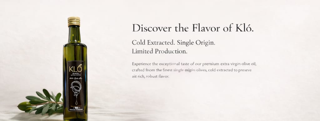A bottle of Kló premium extra virgin olive oil with a dark green label, positioned next to an olive branch, on a neutral background showcasing its flavor and quality.